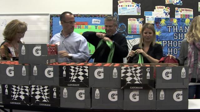 Matt Wallace makes a donation to Blessings in a Backpack